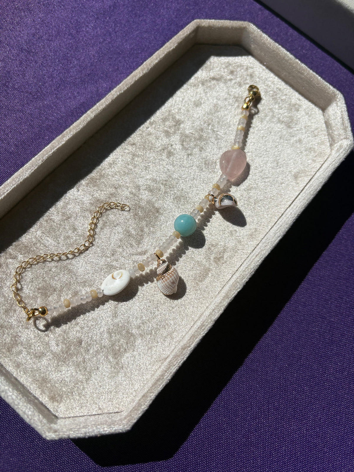 Amazonite, Rose Quartz, Shiva Shell, Mother of Pearl, Dotted Snail Shell, and Spiky Conch shell charm bracelet
